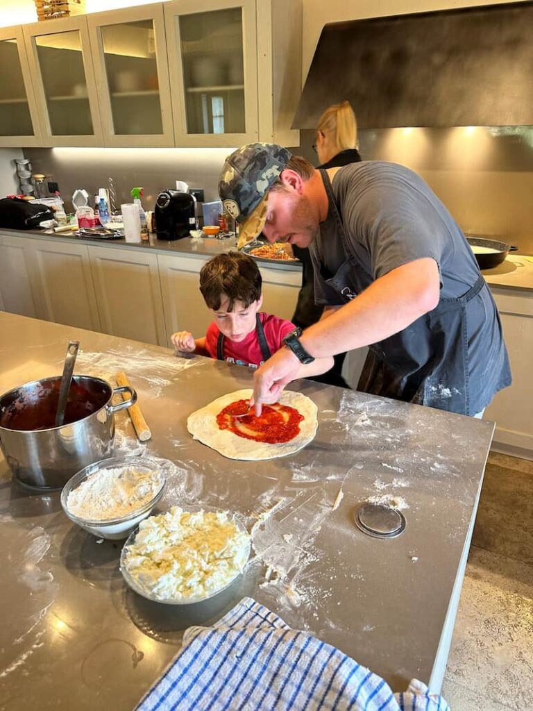 class with man and boy making pizza